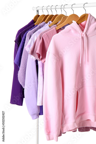 Rack with female clothes on white background
