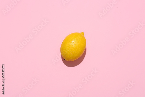 Ripe lemon on pink backgrou...