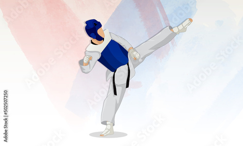A young athlete in a blue vest and a protective helmet on his head makes a kick in the martial arts of taekwondo. Abstract watercolor background.
