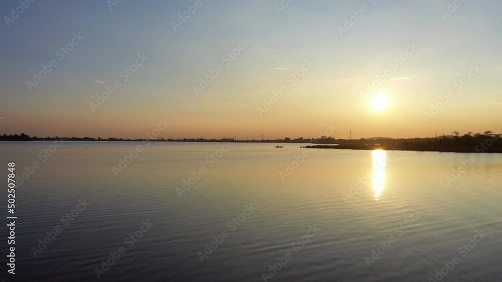 Aerial Panning Low Over Serene Rawal Lake With An Early Morning Sun Low On The Horizon - Islamabad, Pakistan Aerial Panning Low Over Serene Rawal Lake With An Early Morning Sun Low On The Horizon - Islamabad, Pakistan