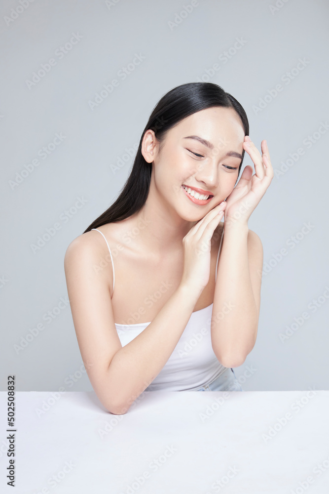 Beauty portrait of happy Asian female face with natural skin on white background Beauty portrait of happy Asian female face with natural skin on white background
