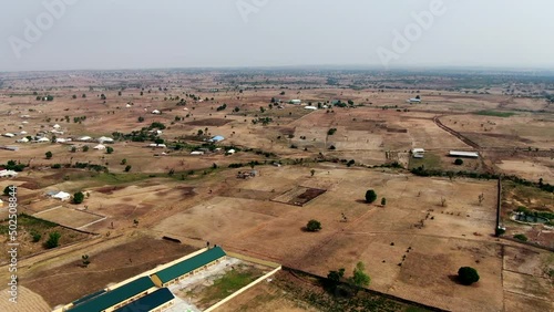 Orbiting aerial parallax view of the underdeveloped countryside near Keffi, Nigeria during the dry season photo