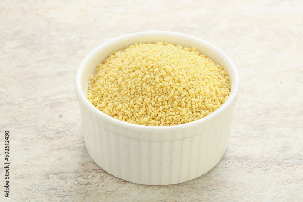 Raw couscous in the bowl Raw couscous in the bowl