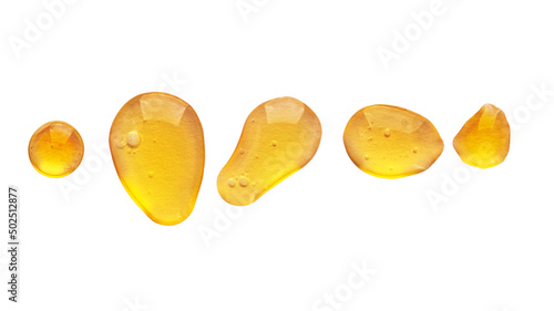 Golden yellow abstract oil bubbles or face serum drops isolated on white background. Oil bubbles macro photography.