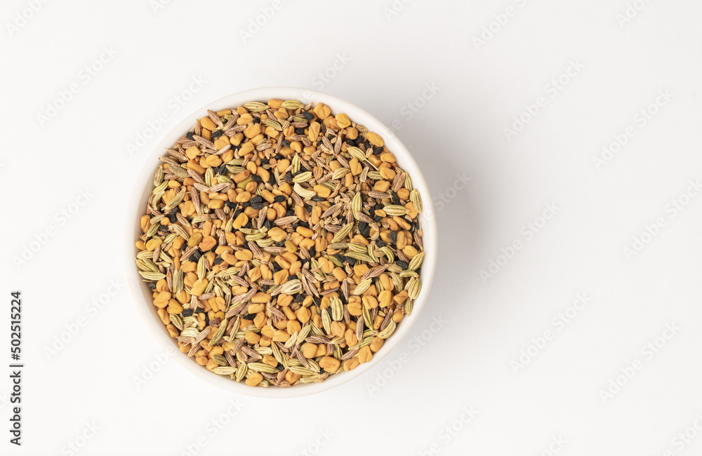 Panch phoron or panchpuran Indian and Bengal five spice seeds blend for cooking consisting of fenugreek, fennel, cumin, mustard seeds, onion seeds or black cumin in bowl on white background Panch phoron or panchpuran Indian and Bengal five spice seeds blend for cooking consisting of fenugreek, fennel, cumin, mustard seeds, onion seeds or black cumin in bowl on white background