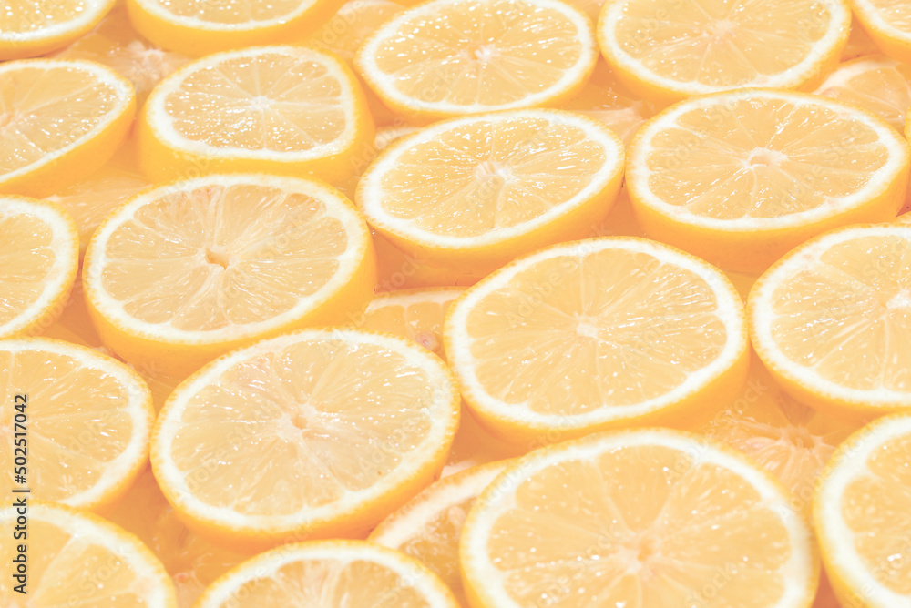 A slices of fresh juicy yellow lemons. Texture background, pattern. A slices of fresh juicy yellow lemons. Texture background, pattern.