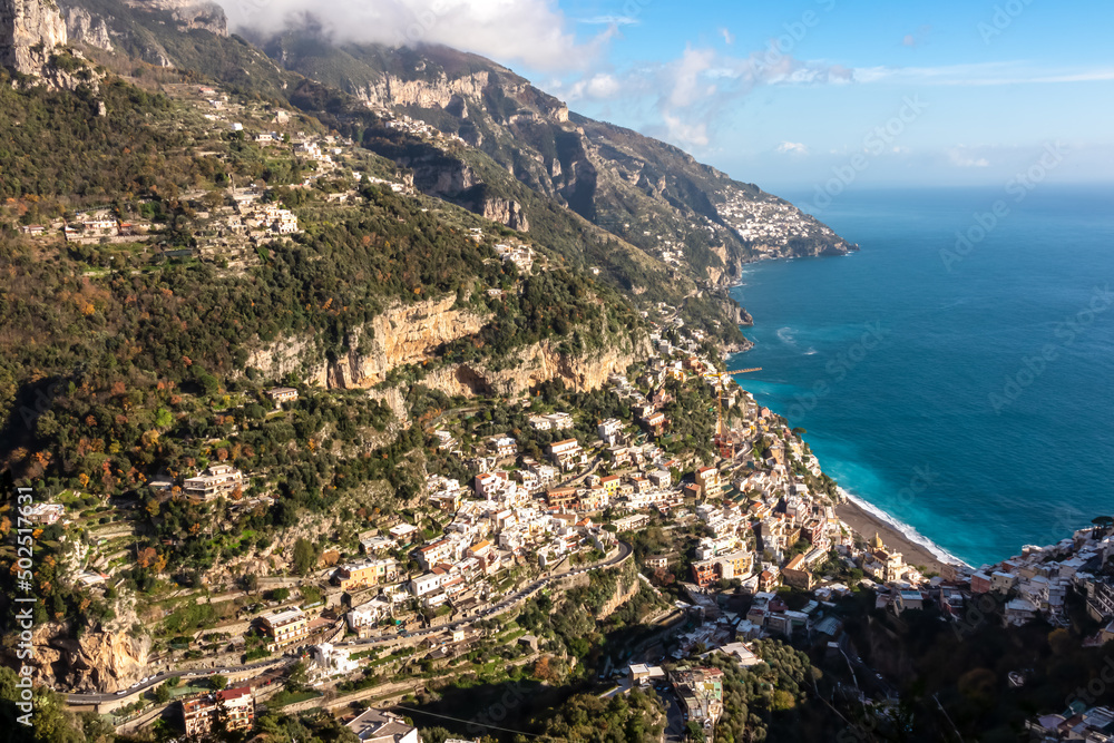 Panoramic aerial view from hiking trail leading to coastal town of Positano. Hiking in Lattari Mountains, Apennines, Amalfi Coast, Campania, Italy, Europe. Vacation at Tyrrhenian and Mediterranean Sea