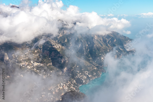 Panoramic view from Monte Comune on the coastal town Positano appearing from clouds. Magical hiking above thick fog in Lattari Mountains, Apennines, Amalfi Coast, Campania, Italy, Europe. Misty vibes © Chris