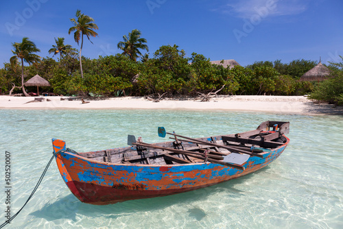 Old wooden boat in beautiful bay in Maldives