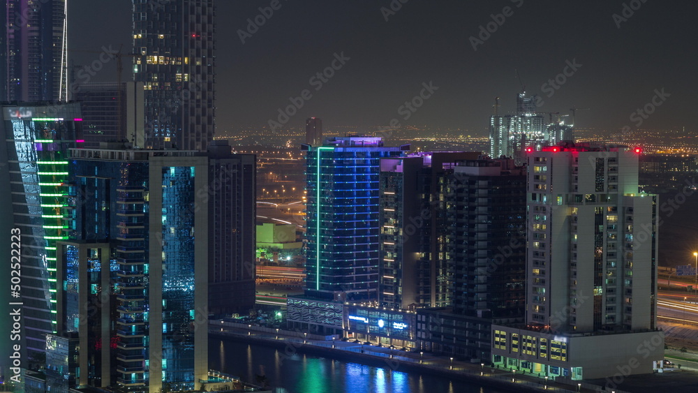 Skyscrapers at the Business Bay aerial night timelapse in Dubai, United Arab Emirates