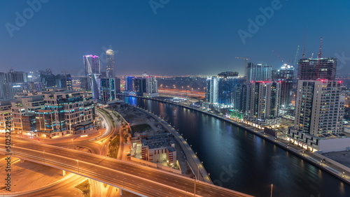 Skyscrapers at the Business Bay aerial day to night timelapse in Dubai  United Arab Emirates