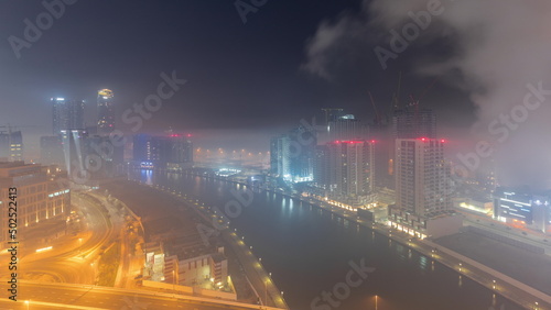 Modern city architecture in Business bay district before sunrise. Panoramic view of Dubai s skyscrapers all night timelapse