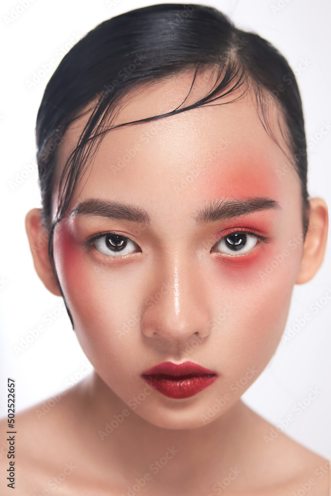 Closeup photo of Beauty Asia girl with a great skin texture with impressive Asia vibes makeup in the white background