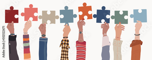 Human resources concept. Raised arms and hand up of multicultural business people holding a jigsaw puzzle piece. Job occupation and employment. Employee recruitment. Candidate