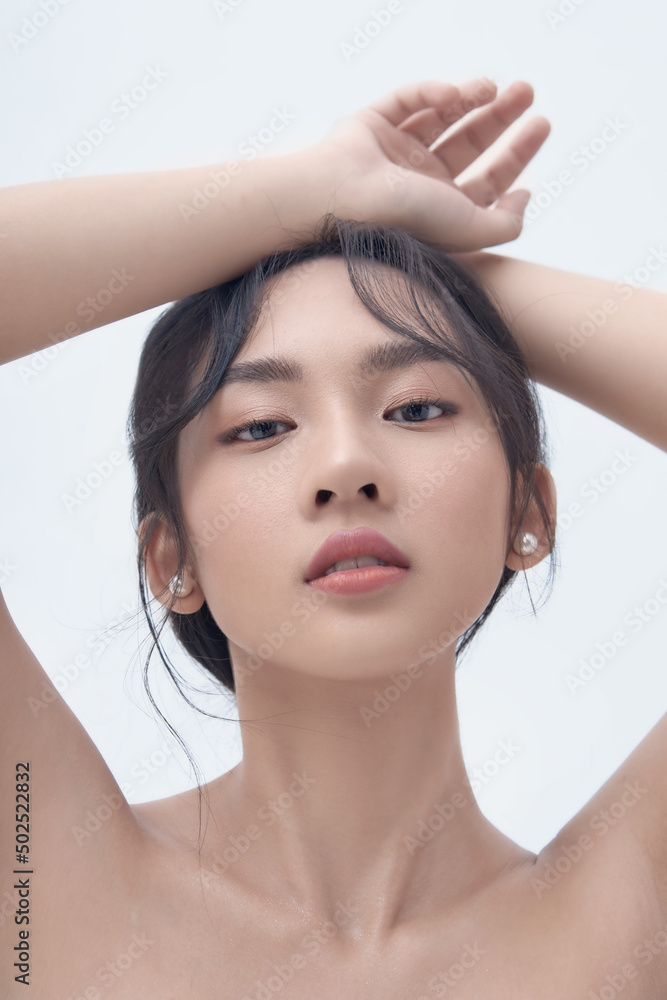 Naklejka premium Beauty portrait of Asian female face with natural skin on white background