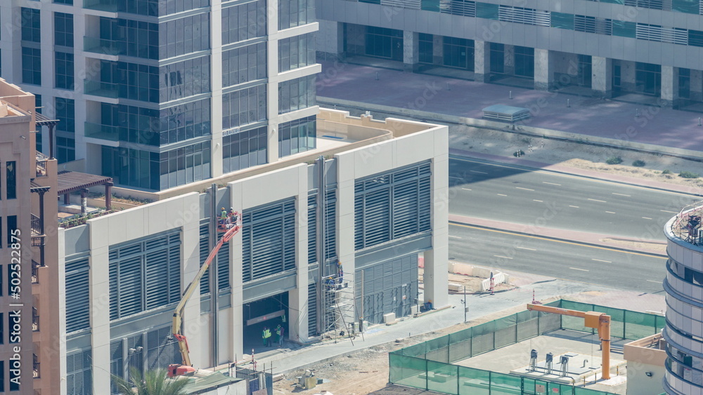 Builder on a Lift Platform on a construction site timelapse. Man at work