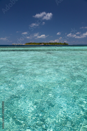 Vertical Seascape from a Lagoon with a Resort Island on Horizon line in Maldives