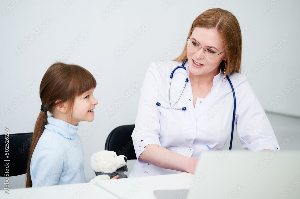Female caucasian doctor examining little girl in office Female caucasian doctor examining little girl in office