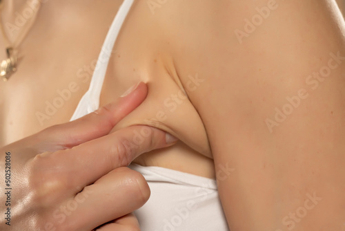 Armpit fat at woman between 30-40 years old dressed in a sporty bra. closeup photo