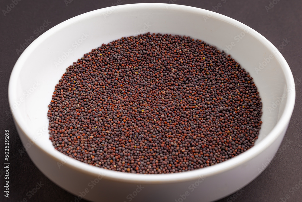 black mustards (kaduku) in a white bowl black mustards (kaduku) in a white bowl