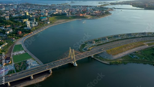 Panoramic summer footage of Millenium bridge. Tatarstan, Russia. Kazan city capital. City centre and landmark line with sunny weather. Sights, churches and mosque. River and cars. Travel destination