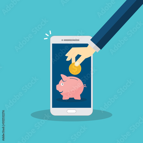 Donate, donation concept. Human hand with gold coin and piggy bank on mobile phone.