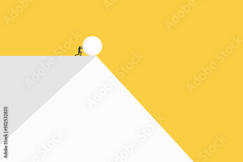 Businessman pushing heavy debt down the cliff. Business concept photo