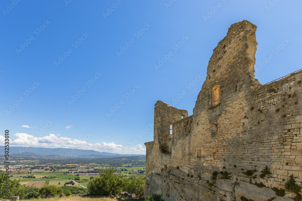 Ruins of Chateau du Marquis de Sade, overview to Calavon valley on sunny summer day, Vaucluse, France