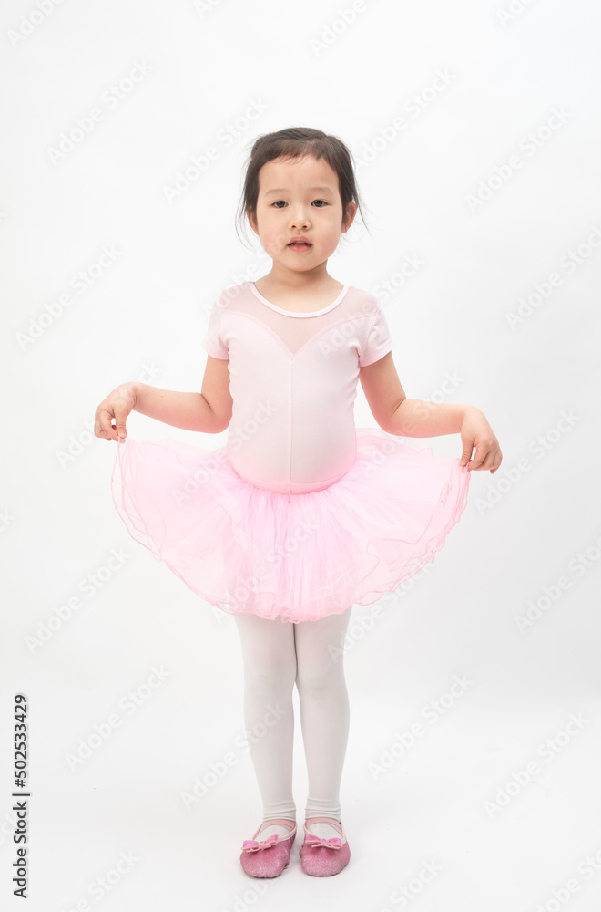 The beautiful little girl is doing gymnastics on a white background The beautiful little girl is doing gymnastics on a white background