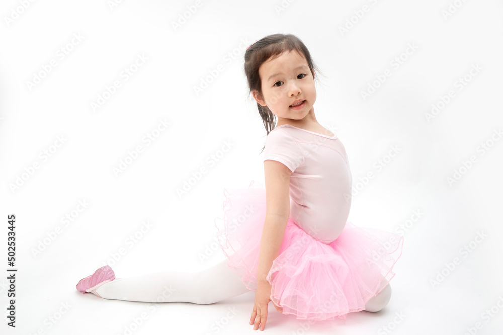 The beautiful little girl is doing gymnastics on a white background The beautiful little girl is doing gymnastics on a white background