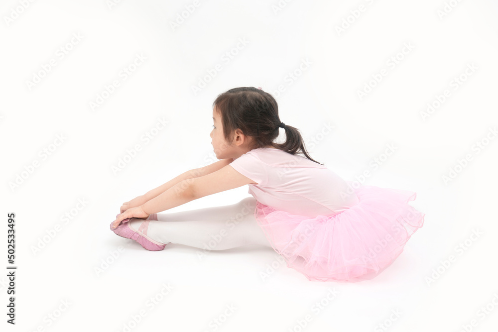 The beautiful little girl is doing gymnastics on a white background The beautiful little girl is doing gymnastics on a white background