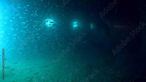 Wallpaper Mural Under water scuba diving film - Inside the wreck of HTMS Sattakut - with divers with flash lights and plenty of small fish - Southern ThailandSouthern Thailand Torontodigital.ca