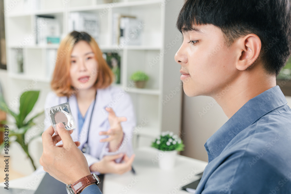 Healthcare and safe sex concept concept, Teenager boy meeting with doctor about condom use in clinic. Healthcare and safe sex concept concept, Teenager boy meeting with doctor about condom use in clinic.