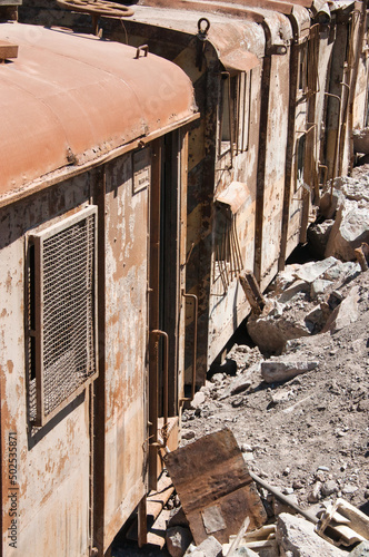 Broke, rusty and deserted freight train with bend metal and debree next to it, in Copiapo, Chile feels like a leftover of former, better times. 