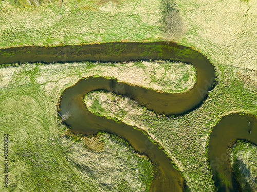 Aerial view of river valley in beautiful spring light, Czech republic, Europe. Meanders of Ploucnice river. River twists like a snake. Swirling river photo