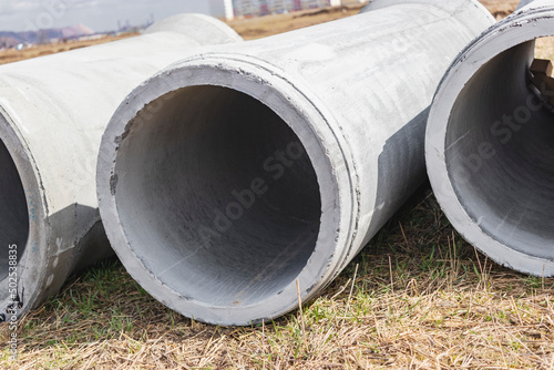 Water pipes for drinking water supply lie on the construction site. Preparation for earthworks for laying an underground pipeline. Modern water supply systems for a residential city. © Anoo