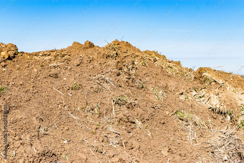 Soil on earth as texture and background. Warning or protective tape at a construction site. Soil on earth as texture and background. Warning or protective tape at a construction site.