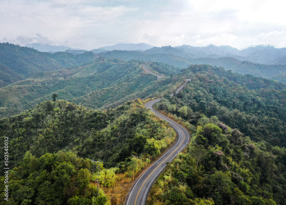 Fototapeta premium Aerial view of Curvy road number 3 in the mountain of Pua district, Nan province, Thailand