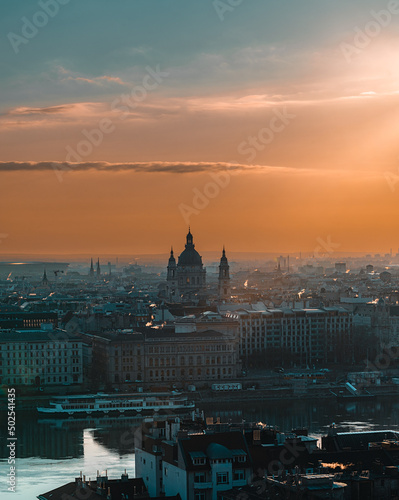 The city skyline of budapest during sunrise with sun beams