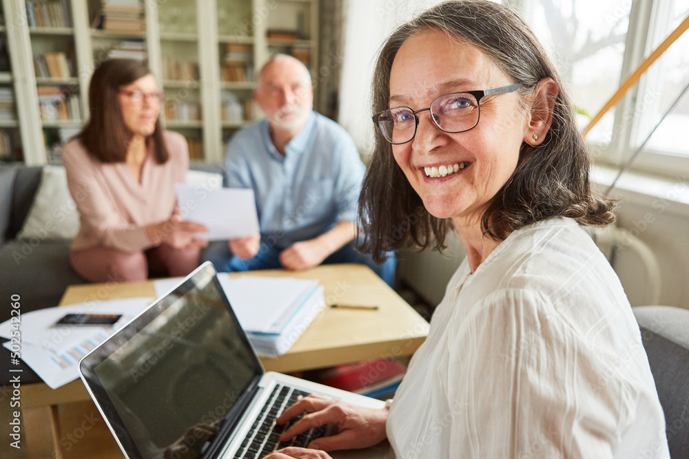 Smiling woman as a financial advisor or broker at the pc Smiling woman as a financial advisor or broker at the pc