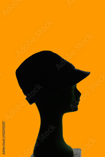 mannequin head silhouette wearing elegant leather hat