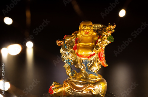 View of the laughing Buddha considered as a symbol of happiness, abundance, contentment and wellbeing photo