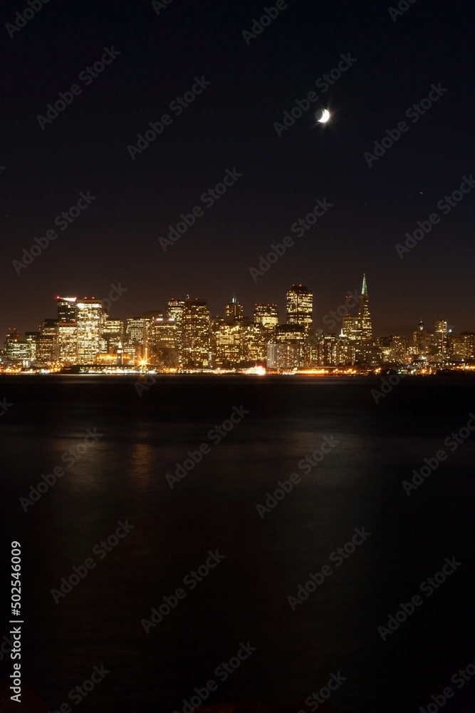 the skyline of San Francisco and moon at night