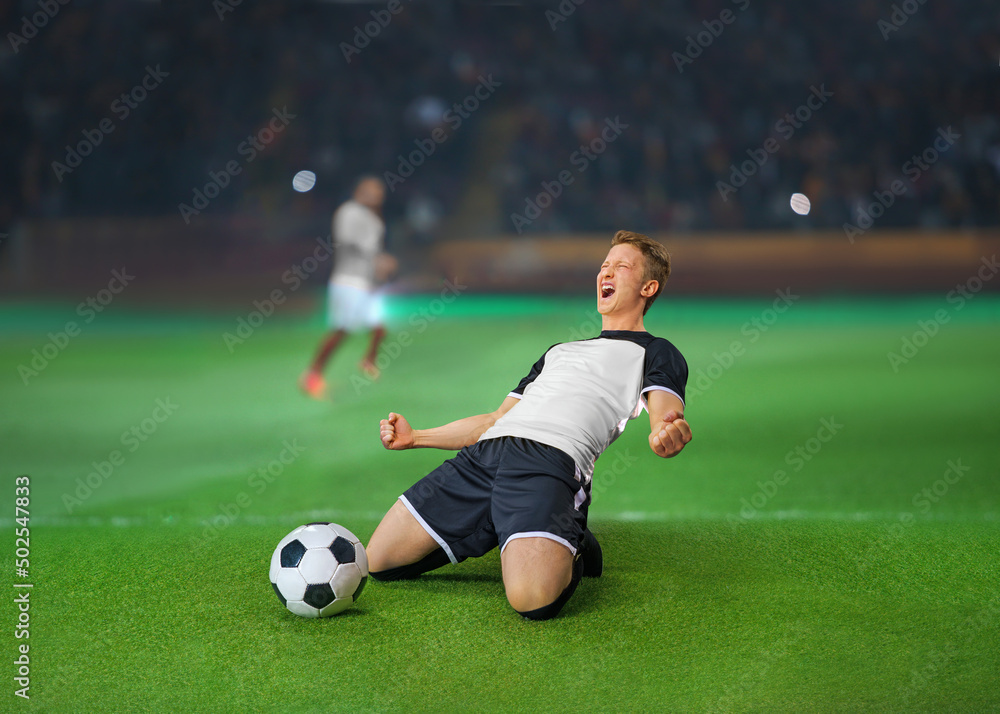 emotional professional soccer player in blue and white uniform with ball standing on knees on football pitch and showing yes gesture at stadium emotional professional soccer player in blue and white uniform with ball standing on knees on football pitch and showing yes gesture at stadium
