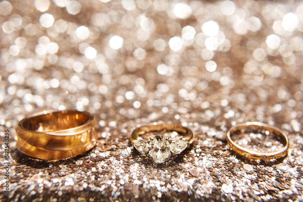 Three wedding ring on a shiny background Three wedding ring on a shiny background