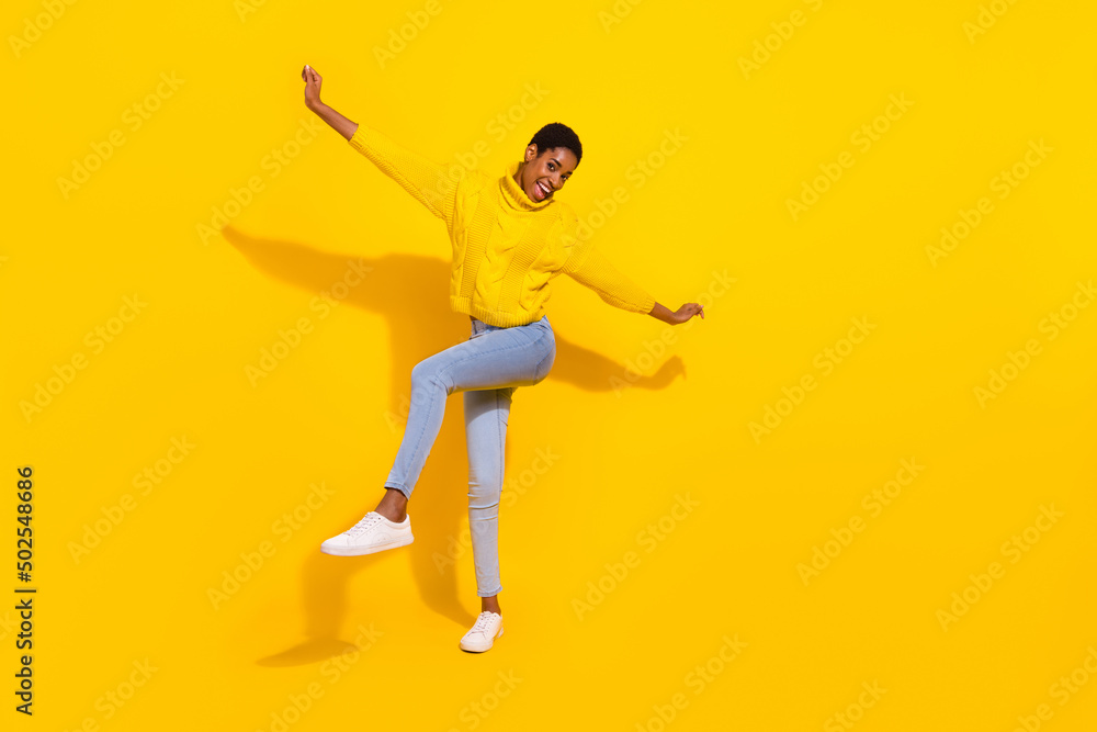 Full length body size view of attractive cheerful thin carefree girl dancing having fun day isolated over bright yellow color background