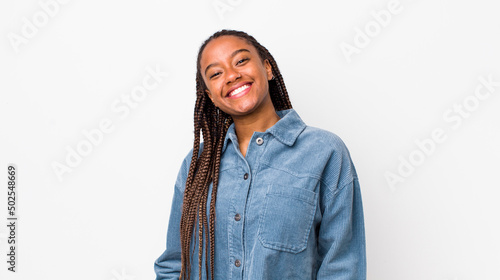 afro pretty woman smiling cheerfully and casually with a positive, happy, confident and relaxed expression