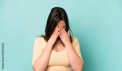 young adult pretty woman feeling sad, frustrated, nervous and depressed, covering face with both hands, crying photo