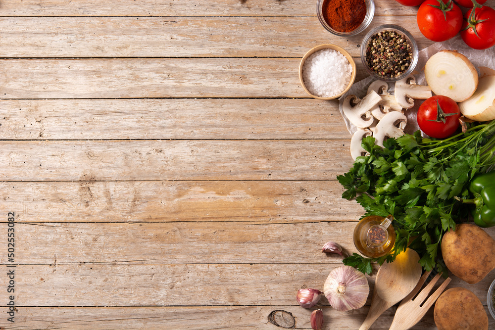 Assortment of vegetables, herbs and spices on wooden table. Top view. Copy space Assortment of vegetables, herbs and spices on wooden table. Top view. Copy space