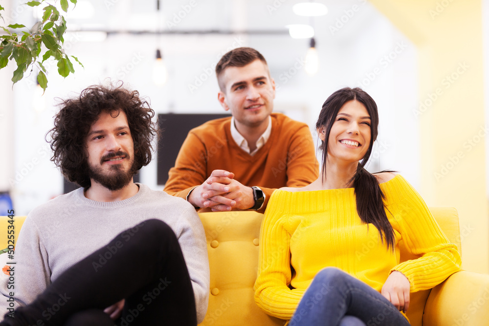 Three caucasian positive and happy colleagues in a modern office.. Three caucasian positive and happy colleagues in a modern office..